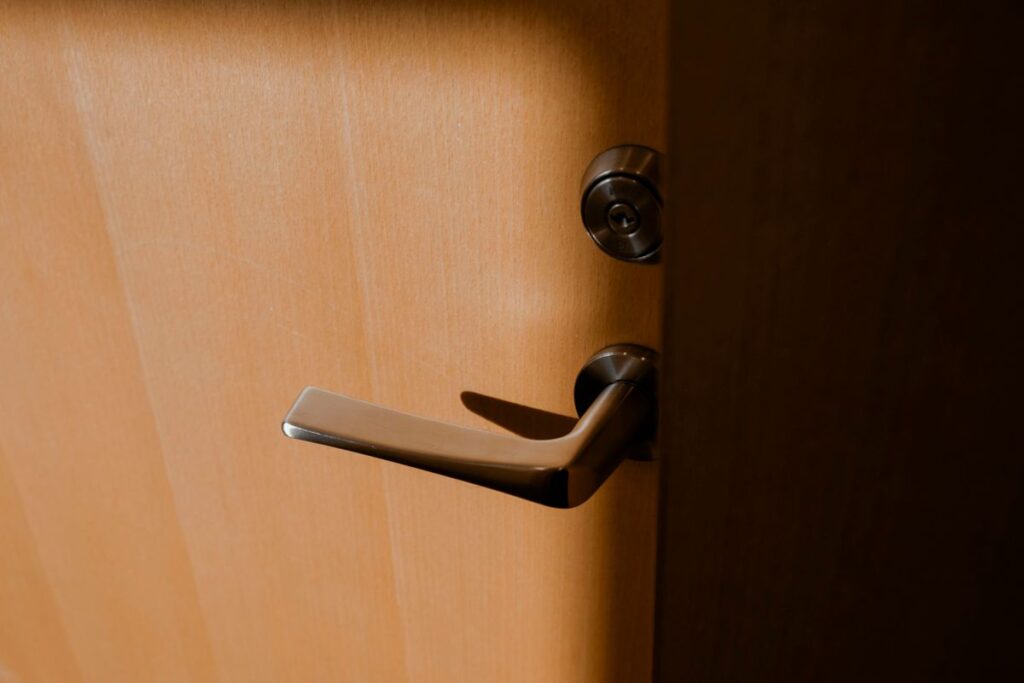Apartment door handle with a separate deadbolt cylinder