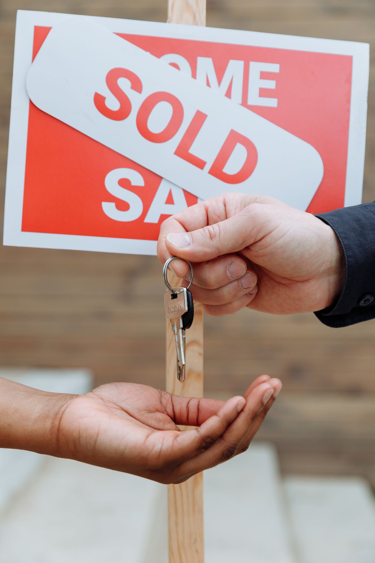 One person handing house keys to another
