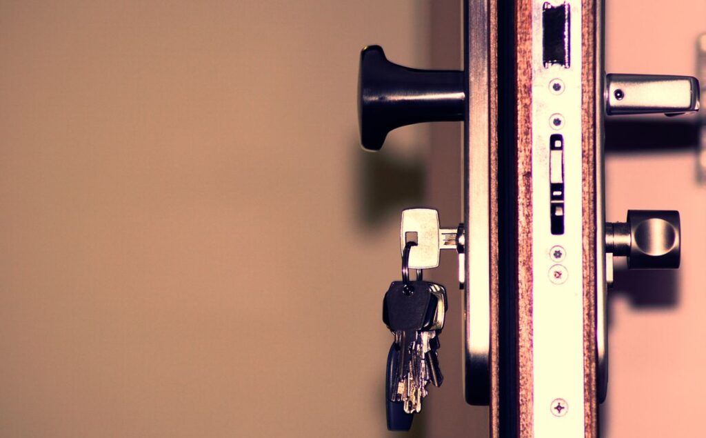 Close-up of a mortise lock edge with keys hanging from the cylinder