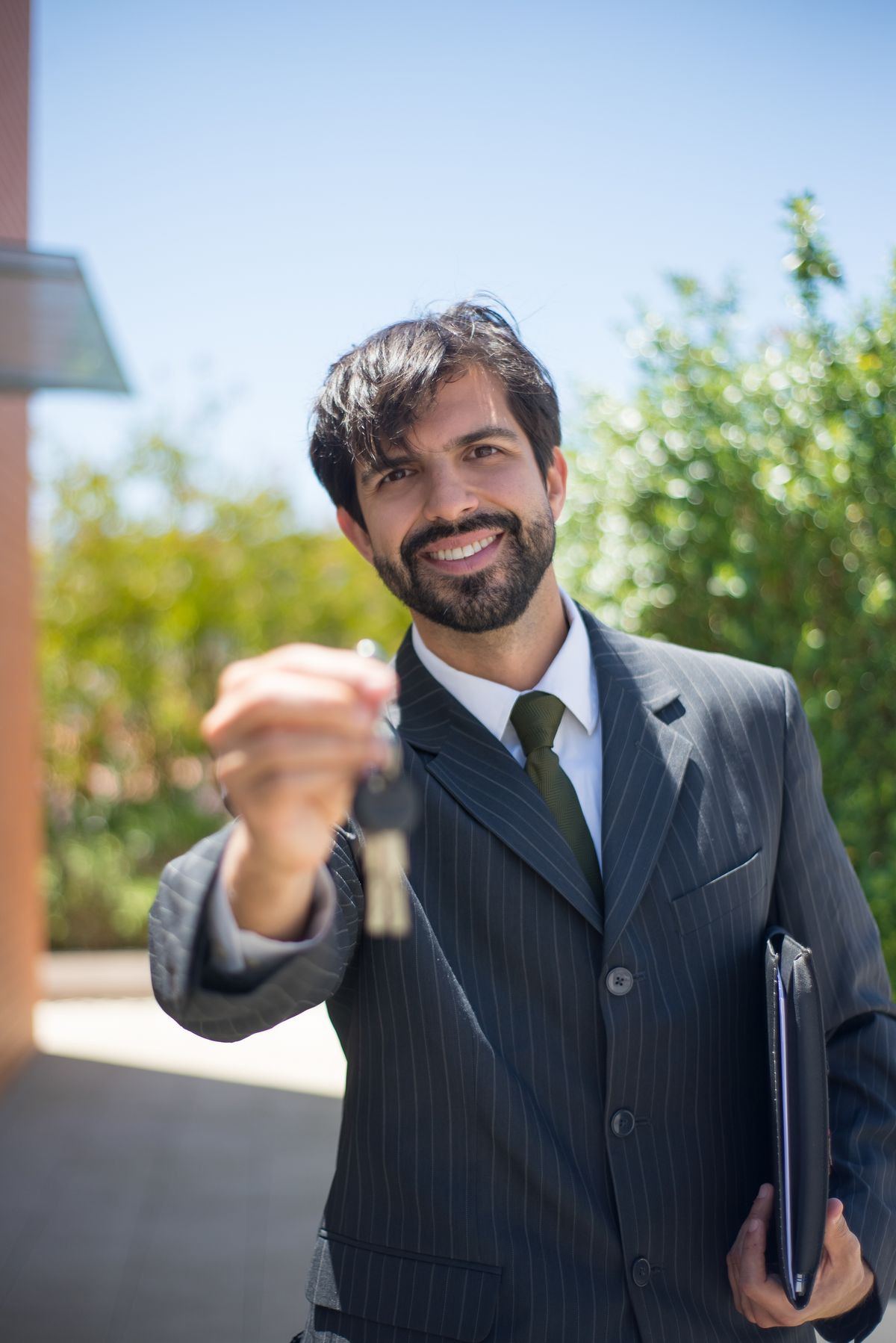 Manager in a suit handing over a set of keys