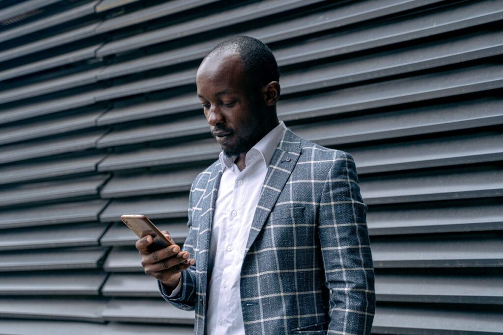 Man checking a locksmith license on his phone before booking a service