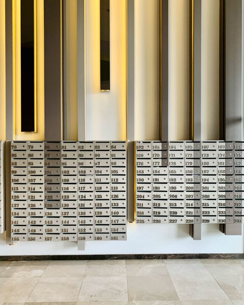 Numbered compartment mailboxes in an apartment building lobby