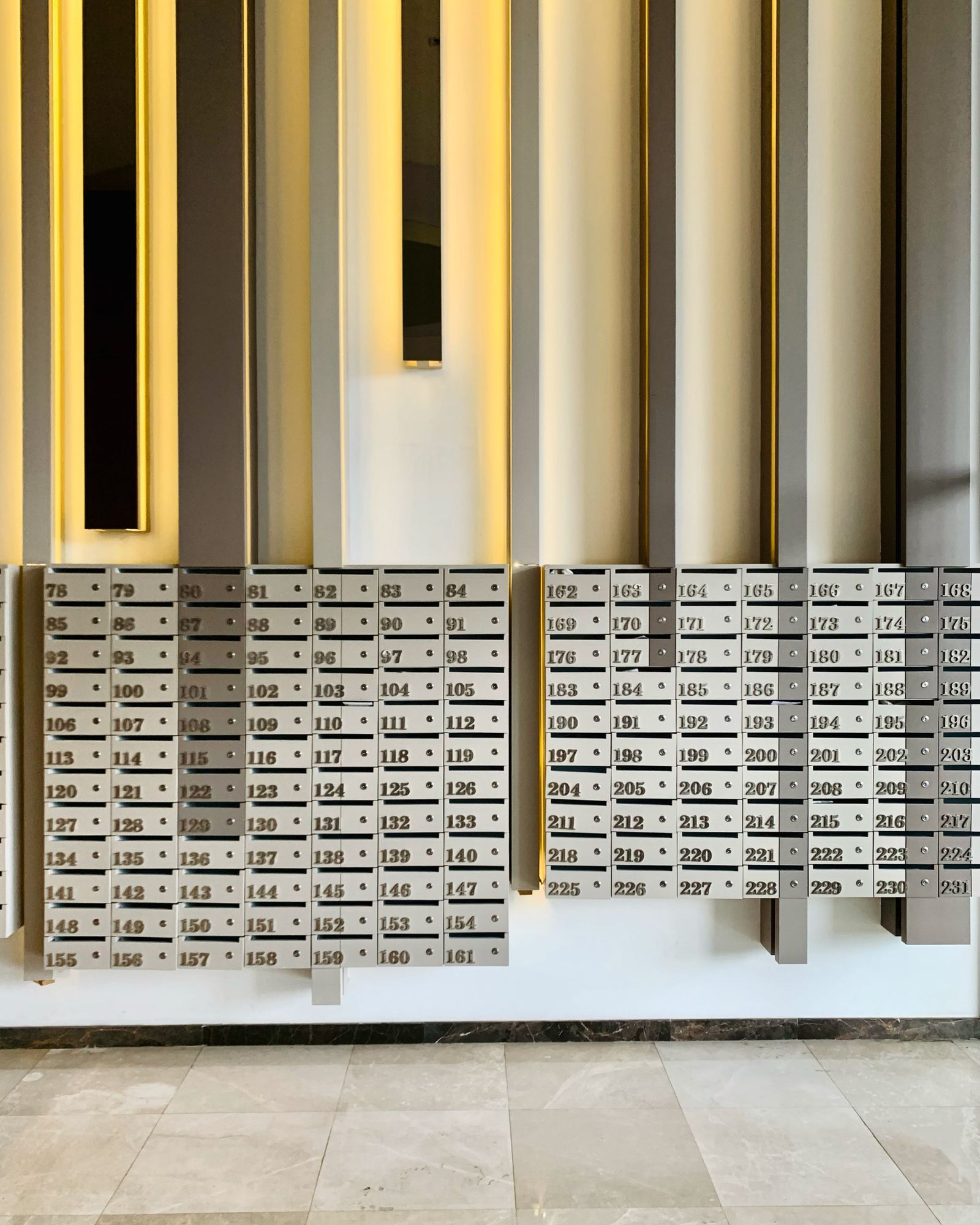 Numbered compartment mailboxes in an apartment building lobby